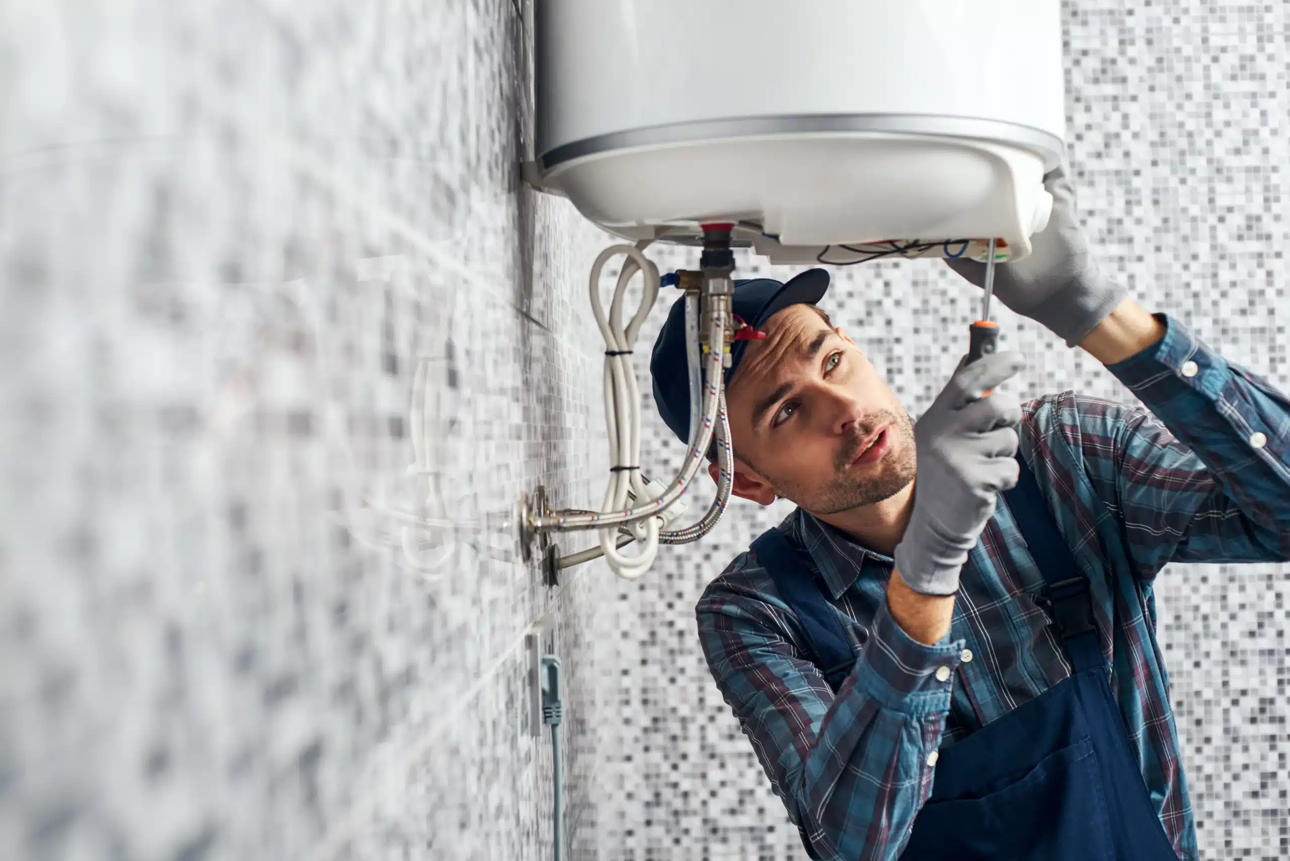Technician working on water heater in Franklin, MA.