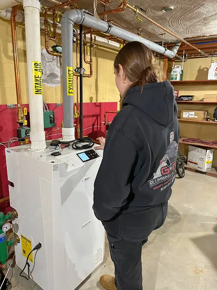 tech inspecting a boiler
