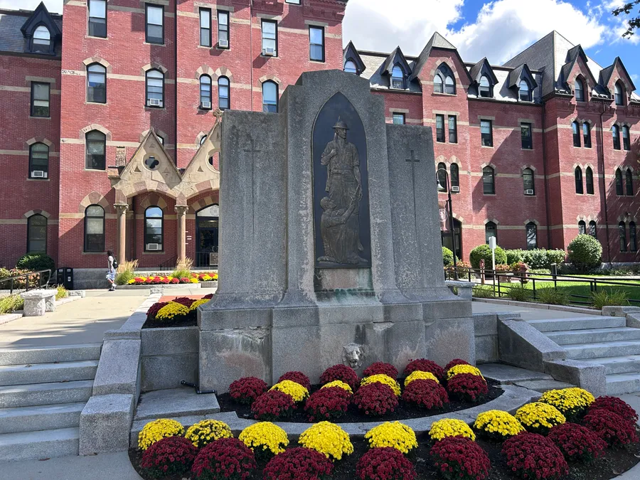 Memorial surrounded by fall mums in Franklin, MA.