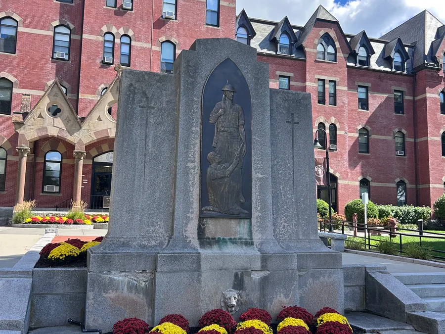 Memorial surrounded by fall mums in Franklin, MA.