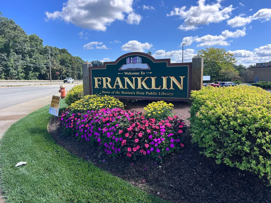 Welcome to Franklin sign surrounded by flowers in Franklin, MA.
