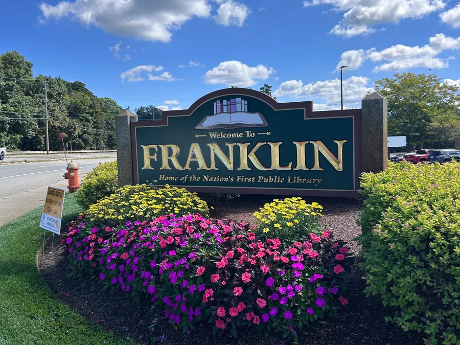 Welcome to Franklin sign surrounded by flowers in Franklin, MA.