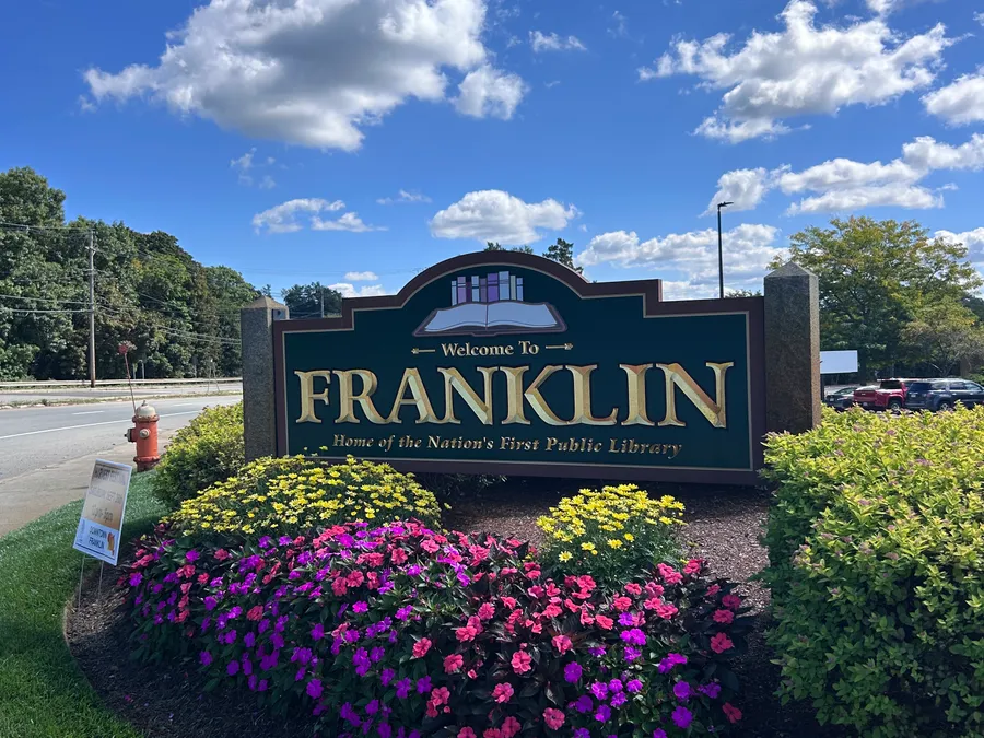 Welcome to Franklin sign surrounded by flowers in Franklin, MA.