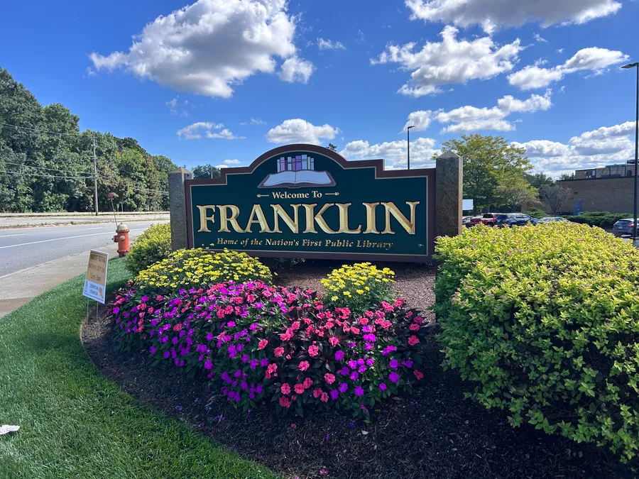 Welcome to Franklin sign surrounded by flowers in Franklin, MA.