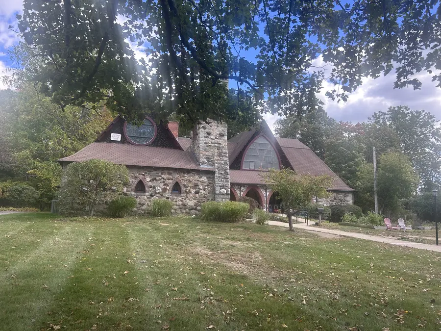 Historic stone building with a round gable window in Medway, MA.