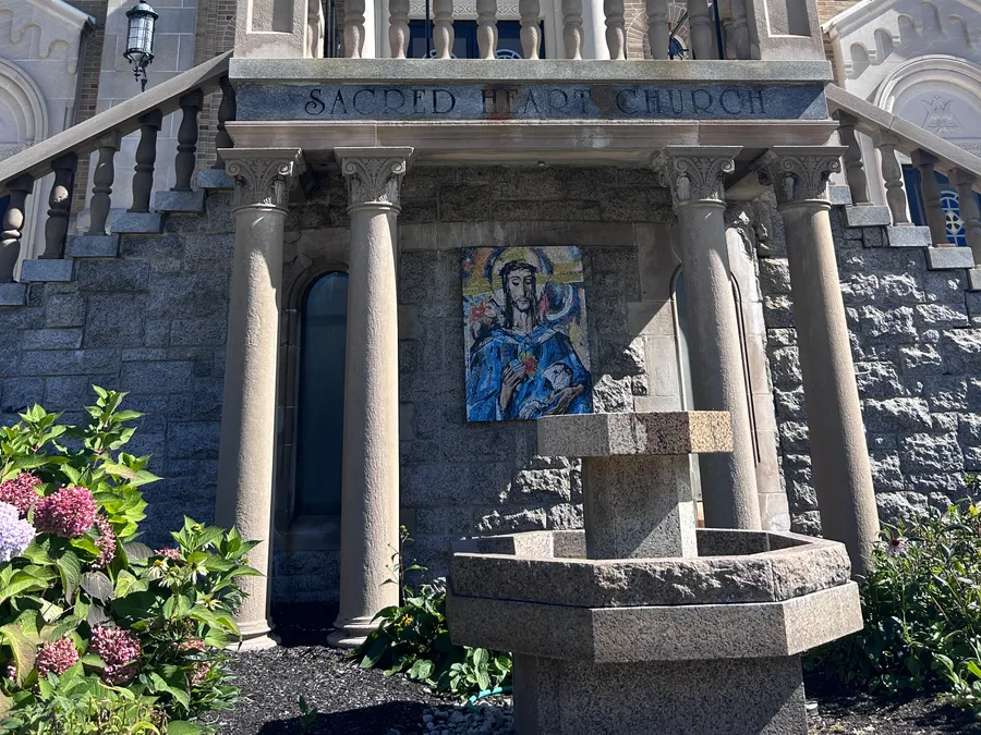 Fountain and mosaic at the entrance of Sacred Heart Church in Milford, MA.