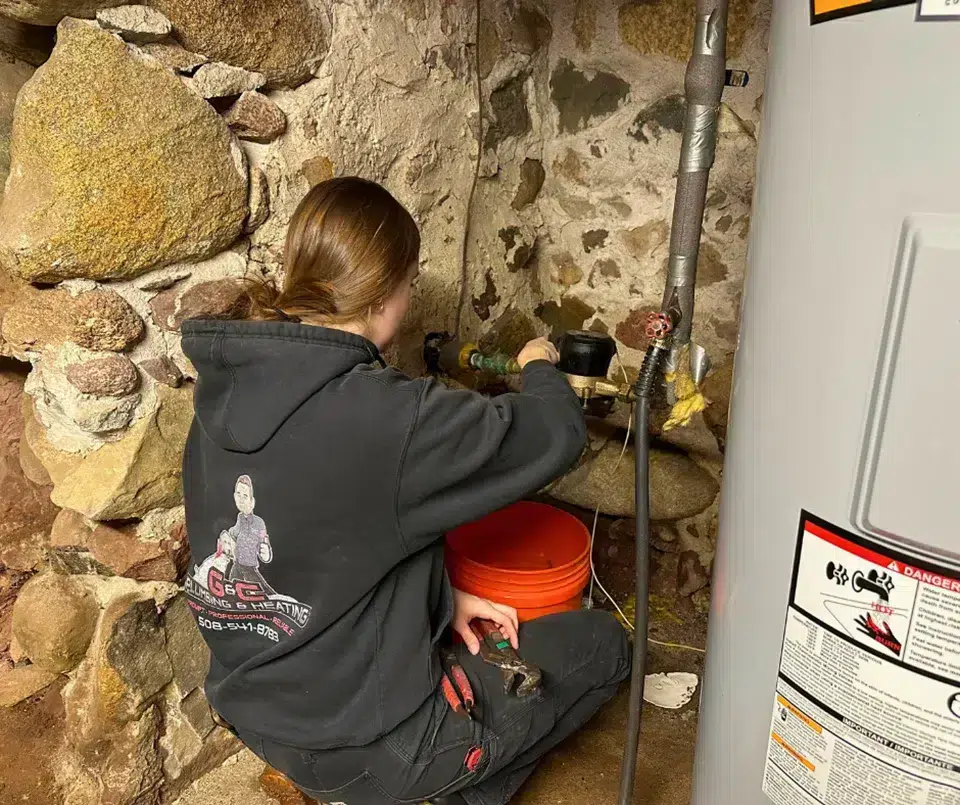 tech fixing a leak