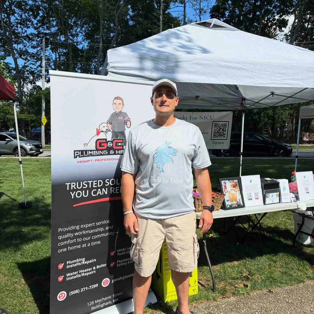 Warrior Family Books for NICU booth next to the G&C Plumbing and Heating banner at the Franklin Farmers Market