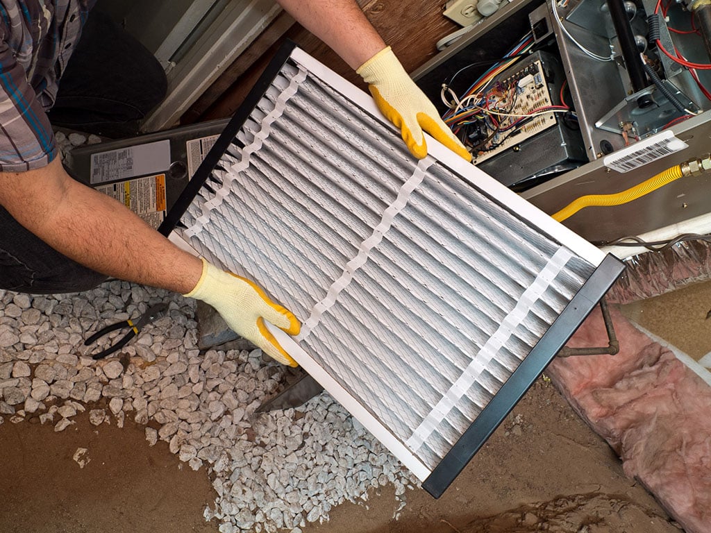 hvac filter being replaced as part of routine hvac maintenance