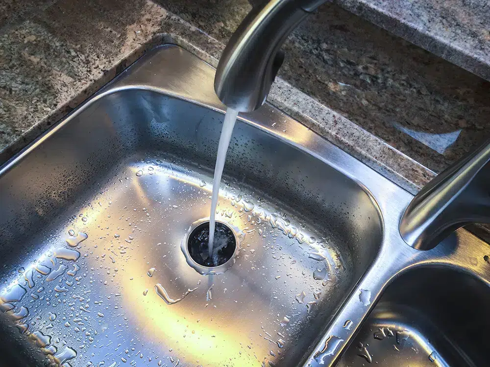 water flowing down kitchen sink in Franklin, MA.