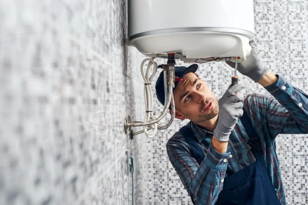 Technician working on water heater in Franklin, MA.