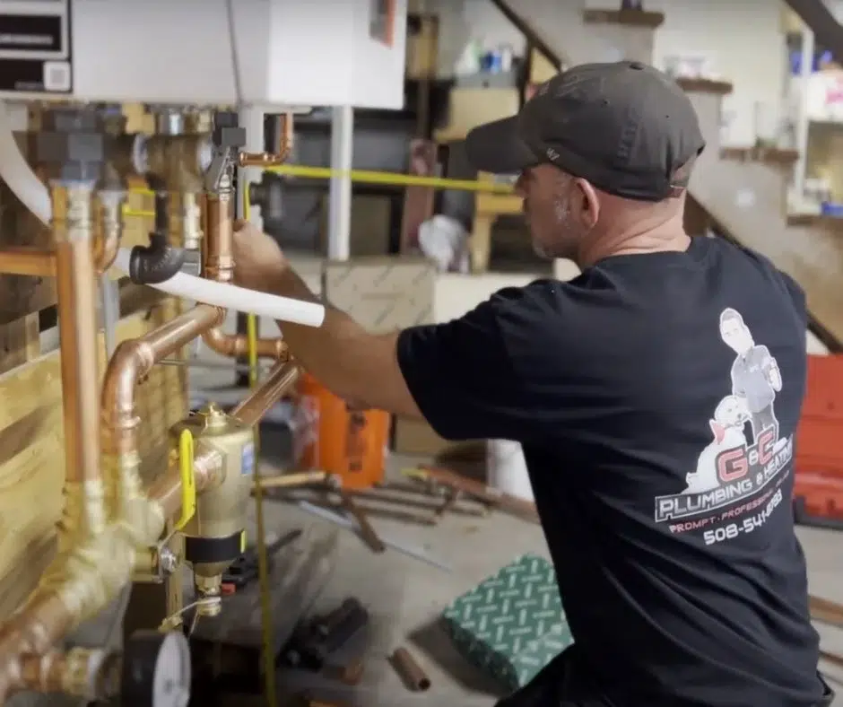 plumber working on pipes