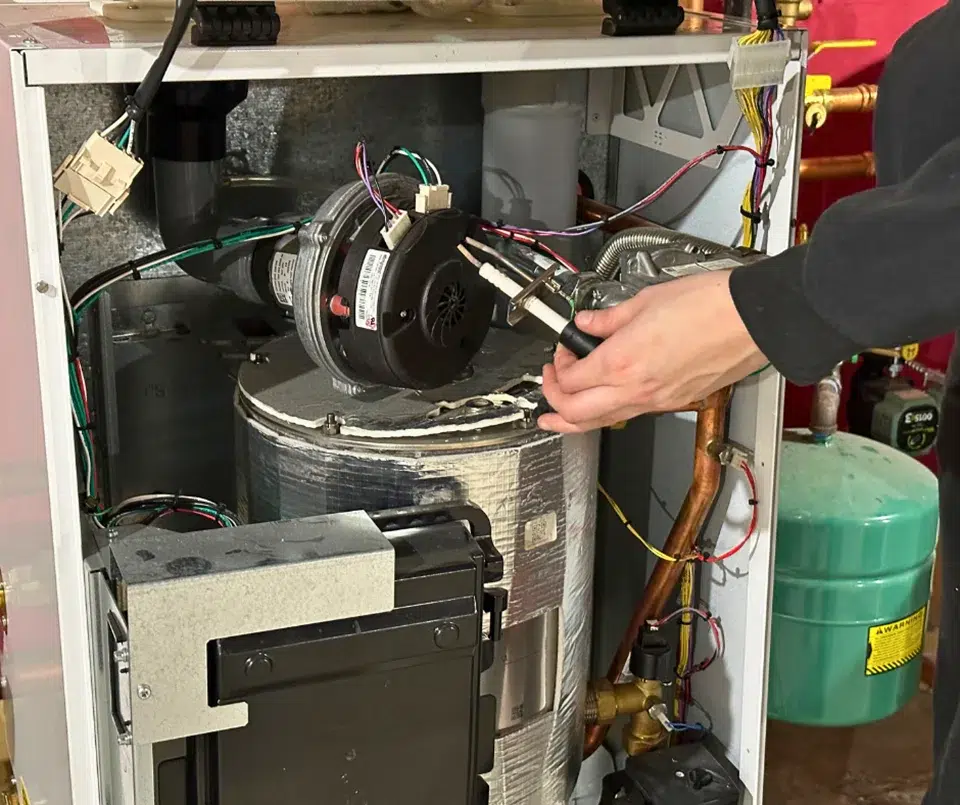 close up of hands working on a boiler