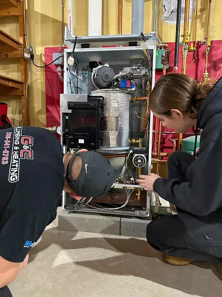 two techs working on a boiler
