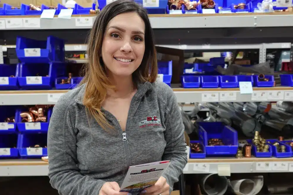 Customer service rep holding pamphlet in Franklin, MA