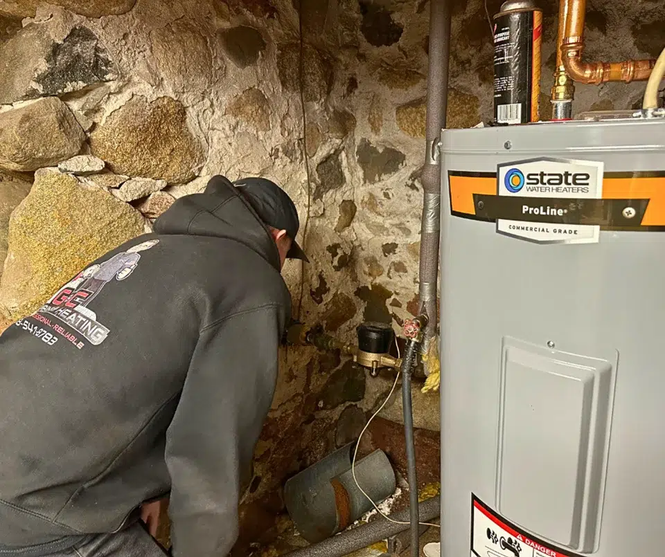 tech inspecting a leak