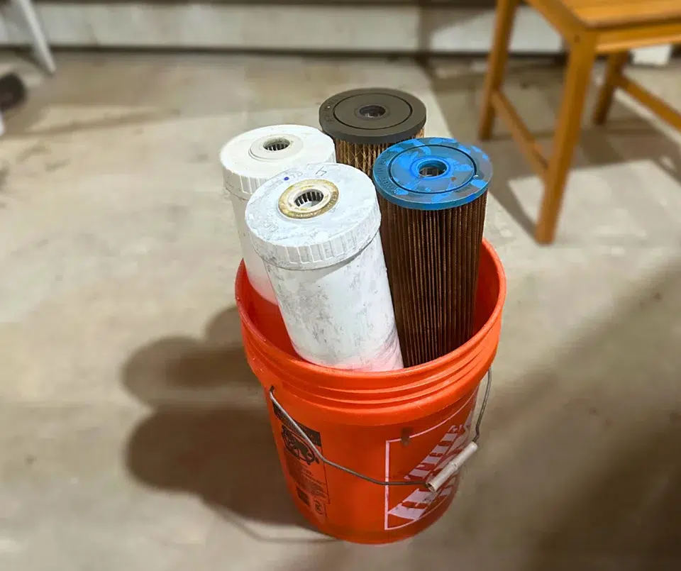 home depot bucket filled with 4 water filter cartridges