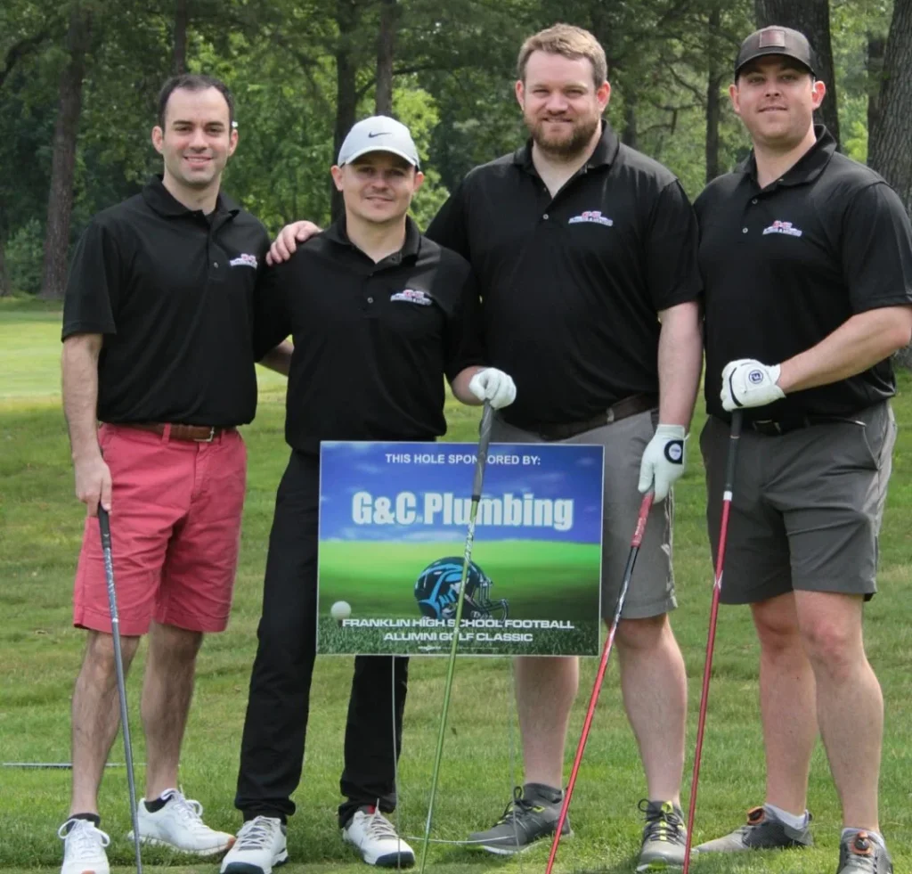 Brandon with team playing golf