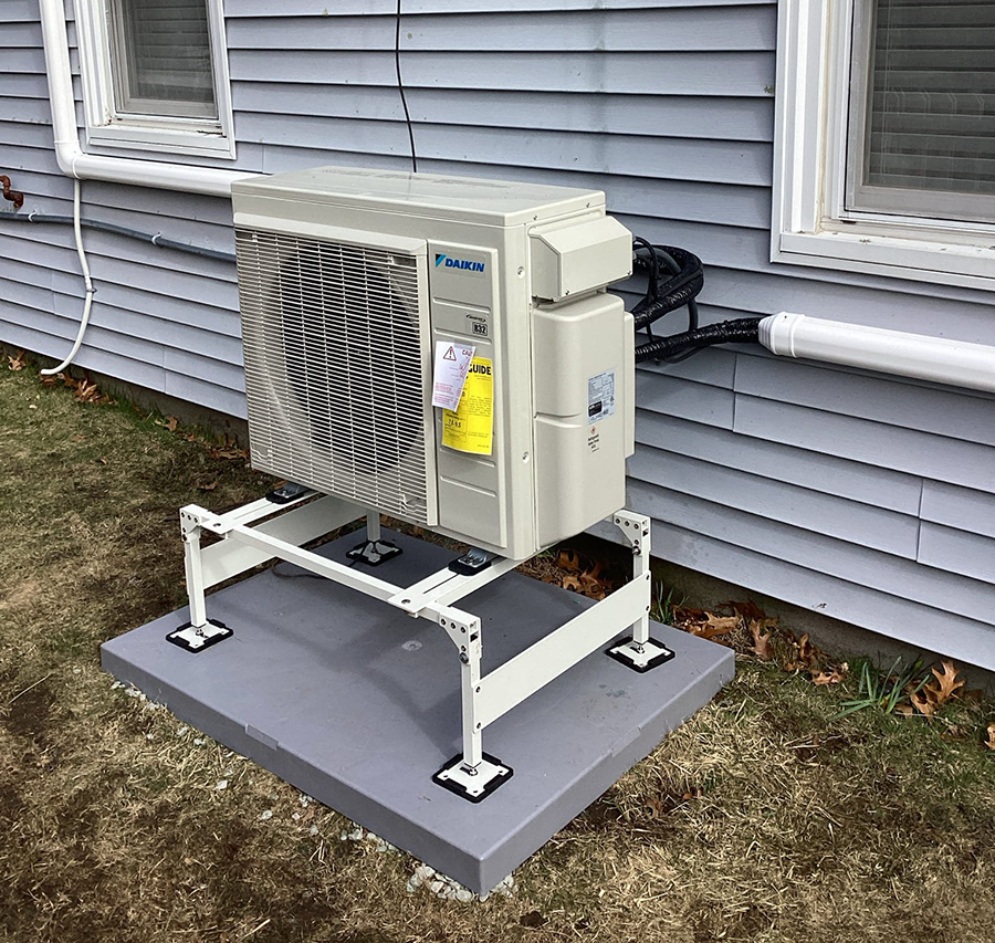 Daikin mini-split outdoor heat pump unit installed on a pad in Franklin, MA by G&C Plumbing & Heating
