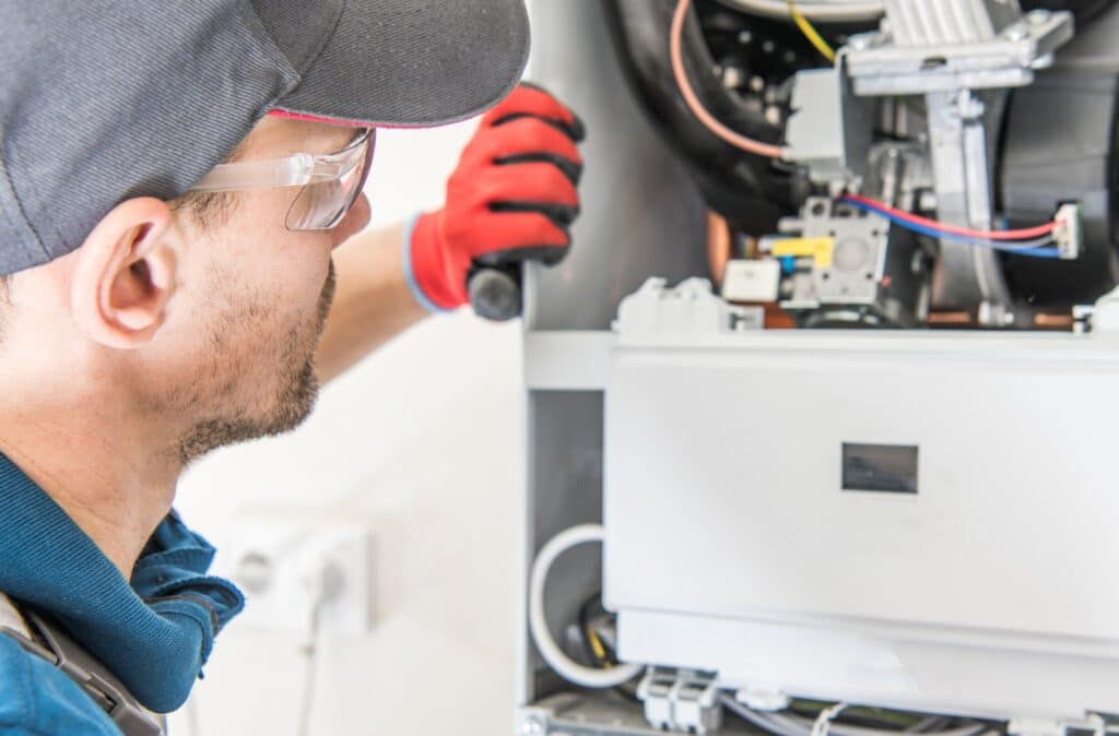 technician performing furnace repair in franklin, ma