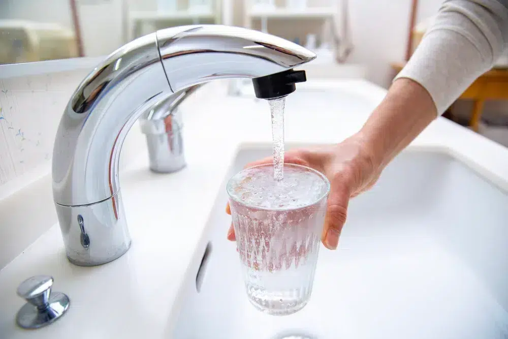 Water from kitchen sink filling up glass in Franklin, MA.
