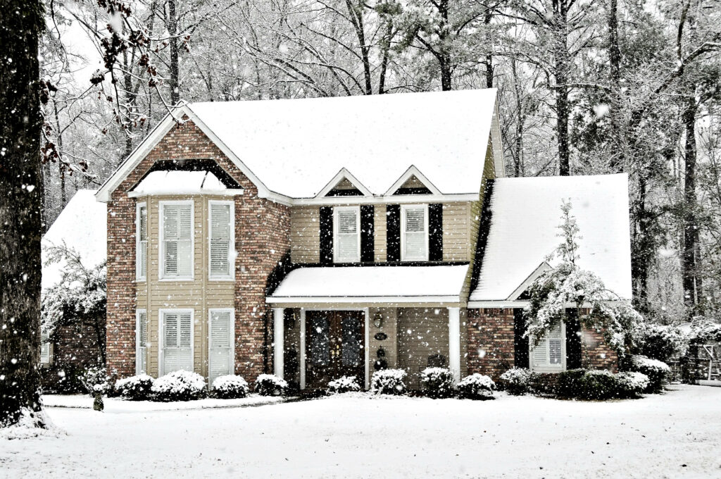 front view of single family home during winter, covered in snow
